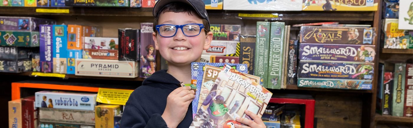 Boy holding comic books